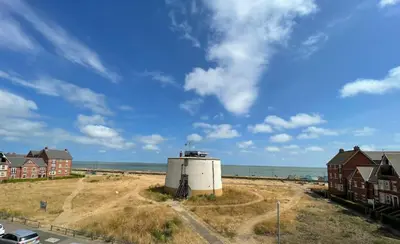 a building on the beach next to the ocean at Luxurious Beach House with spectacular sea views in Felixstowe