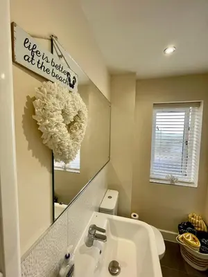 a bathroom with a sink and a mirror at Luxurious Beach House with spectacular sea views in Felixstowe