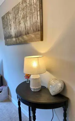 a table with a lamp and a heart on it at Cosy Bungalow Near Open Countryside in Felixstowe