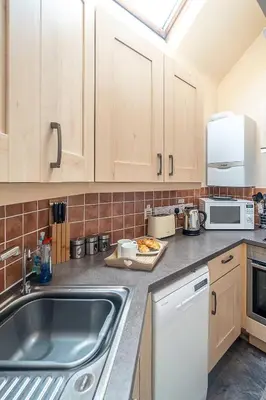 a kitchen with a sink and a counter top at The Haven at Coastguard Court - Aldeburgh Coastal Cottages in Aldeburgh
