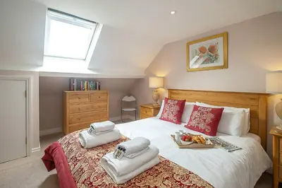 a bedroom with a bed with towels on it at The Haven at Coastguard Court - Aldeburgh Coastal Cottages in Aldeburgh
