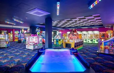 a gaming room with arcade games and a pool table at 1 Martello Beach 8 berth holiday home with pools in Clacton-on-Sea