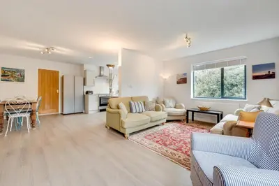 a living room with two couches and a kitchen at 5 Bed in Aldeburgh oc-pops in Aldeburgh