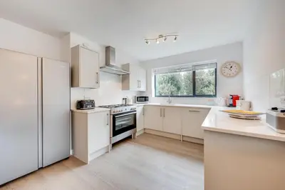 a white kitchen with white appliances and a window at 5 Bed in Aldeburgh oc-pops in Aldeburgh