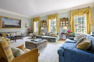 a large living room with blue couches and chairs at Abbey House by Group Retreats in Saffron Walden