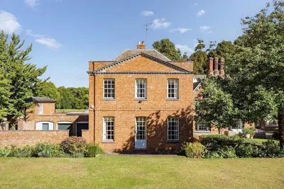 an old brick house with a grassy yard at Abbey House by Group Retreats in Saffron Walden