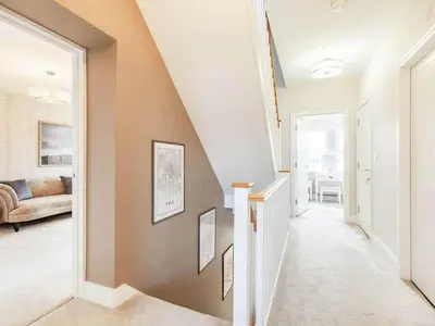a hallway leading to a living room with a staircase at Violet Place in Broomfield
