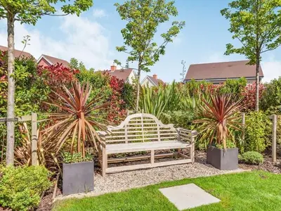 a wooden bench sitting in the middle of a garden at Violet Place in Broomfield