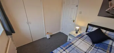 a small bedroom with a bed and a night stand at Shirley L, Milton, Cambridge, 4 BR House, Newly Refurbished in Milton
