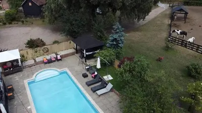 an aerial view of a swimming pool in a backyard at Farmhouse Retreat with Hot Tub, Pool, Horses, Games Room, Free Car Park, Only 45 min from Oxford Circus in Stapleford Tawney