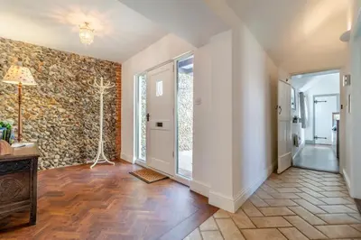 a room with a hallway with a stone wall at Tilly's, a two bedroom holiday retreat with hot tub and views of the pond in Barningham