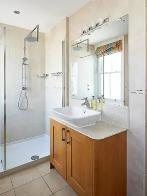 a bathroom with a sink and a shower at 252 Aldeburgh Townhouse - Aldeburgh Coastal Cottages in Aldeburgh