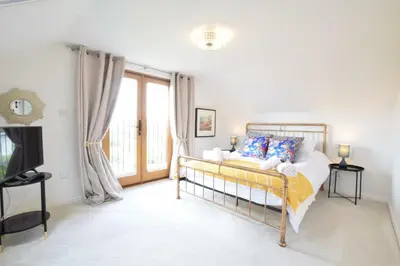 a bedroom with a bed and a large window at Skelder, Parham in Parham