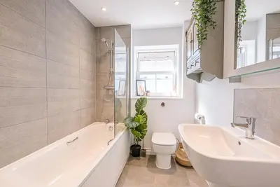 a bathroom with a tub and a sink and a toilet at Martlet Cottage Aldeburgh in Aldeburgh