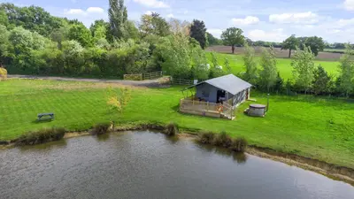 an aerial view of a house next to a river at Finest Retreats - The Herdwick Safari Tent in Hertford