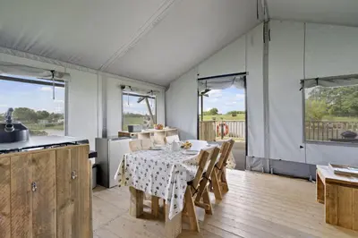 a kitchen and dining room with a table and chairs at Finest Retreats - The Herdwick Safari Tent in Hertford