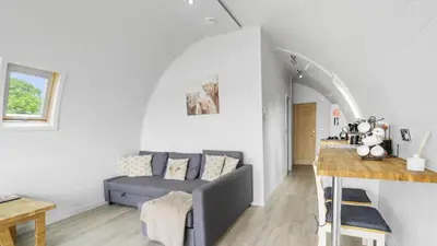 a living room with a couch and a table at Finest Retreats - The Highland Camping Pod in Hertford