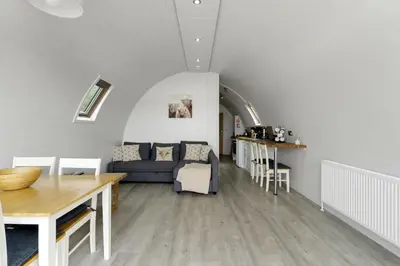 a living room with a couch and a table at Finest Retreats - The Highland Camping Pod in Hertford