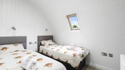 a bedroom with two beds with towels on them at Finest Retreats - The Highland Camping Pod in Hertford
