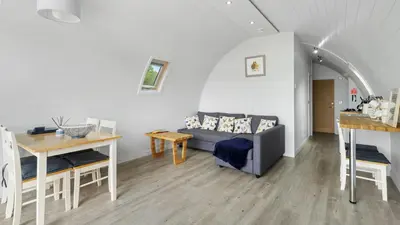 a living room with a couch and a table at Finest Retreats - The Chicken Coop in Hertford