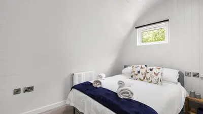 a bedroom with a bed with stuffed animals on it at Finest Retreats - The Chicken Coop in Hertford
