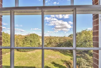 a window with a view of a field seen through it at Harkstead Hall By Group Retreats in Ipswich
