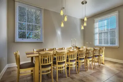 a dining room with a long table and chairs at Harkstead Hall By Group Retreats in Ipswich