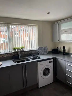 a kitchen with a washing machine and a sink at Sea Breeze in Harwich