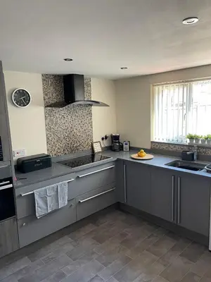 a kitchen with gray counters and a sink at Sea Breeze in Harwich