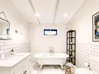 a white bathroom with two sinks and a tub at Little Owl by The Suffolk Cottage Collection in Aldeburgh