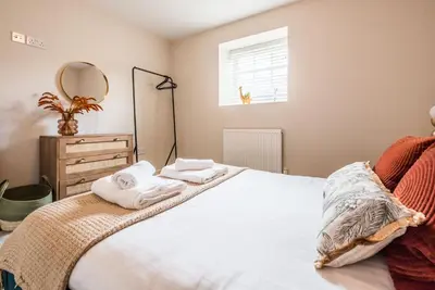 a bedroom with a bed with towels on it at Guildhall Street Apartment, Bury St Edmunds in Bury Saint Edmunds