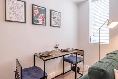 a living room with a table and chairs and a couch at Guildhall Street Apartment, Bury St Edmunds in Bury Saint Edmunds