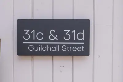 a sign on the side of a building at Guildhall Street Apartment, Bury St Edmunds in Bury Saint Edmunds
