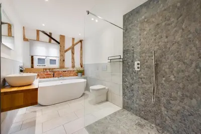 a bathroom with a tub and a toilet and a shower at 3 Bed in Kersey oc-tcbk in Kersey