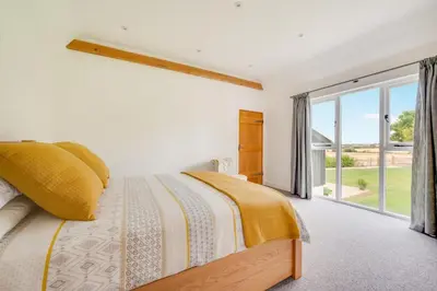 a bedroom with a bed and a large window at 3 Bed in Kersey oc-tcbk in Kersey