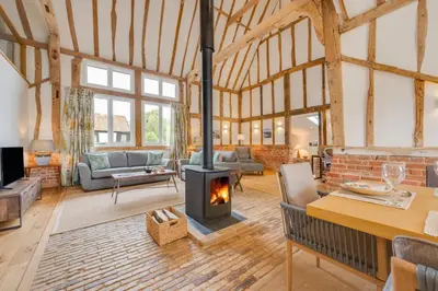 a living room with a wood stove in it at 3 Bed in Kersey oc-tcbk in Kersey