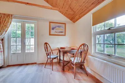 a dining room with a table and two chairs at 1 Bed in Debenham oc-glah in Worlingworth