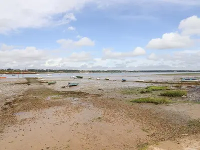 a beach with boats sitting in the water at Wherry Cottage in Manningtree