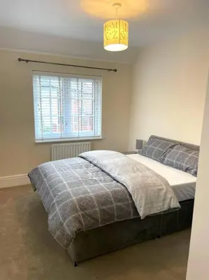 a bedroom with a bed and a window at Fantastic Holiday Home in Laindon
