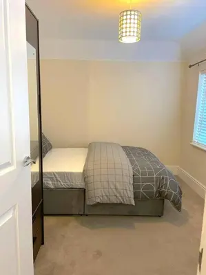 a small bedroom with a bed and a window at Fantastic Holiday Home in Laindon