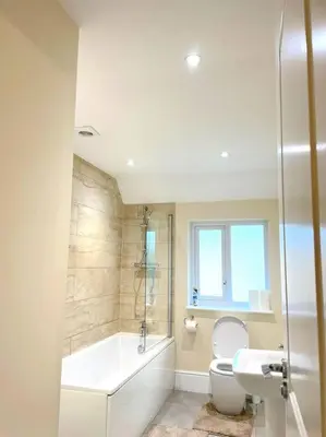 a bathroom with a tub and a toilet and a sink at Fantastic Holiday Home in Laindon