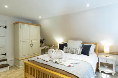 a bedroom with a bed with two towels on it at Vine Cottage in Walsham le Willows