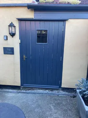 a blue garage door with a window on a house at Top House -Stylish property in village location in Bildeston
