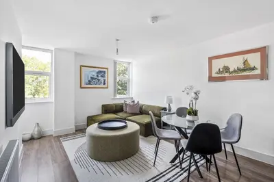a living room with a couch and a table at Luxurious 2 Bedroom Apartment with Free Parking, Sky TV, Sports, Movies & Netflix in Chelmsford