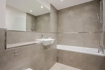 a bathroom with a sink and a bath tub at Luxurious 2 Bedroom Apartment with Free Parking, Sky TV, Sports, Movies & Netflix in Chelmsford