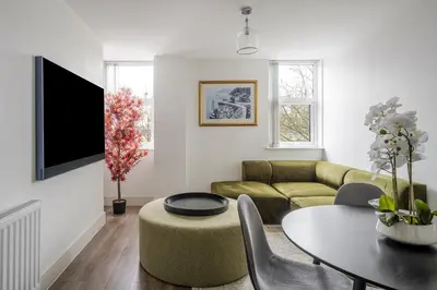 a living room with a couch and a table at Luxurious 2 Bedroom Apartment with Free Parking, Sky TV, Sports, Movies & Netflix in Chelmsford