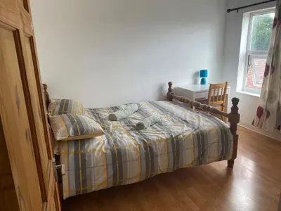 a bedroom with a bed with two pairs of shoes on it at 160 Exning Road in Newmarket