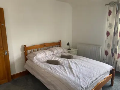 a bedroom with a bed with two pillows on it at 160 Exning Road in Newmarket
