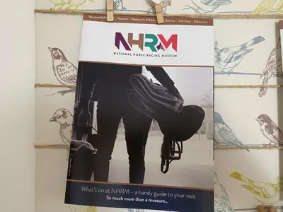 a poster of a person holding a shoe on a shelf at 160 Exning Road in Newmarket
