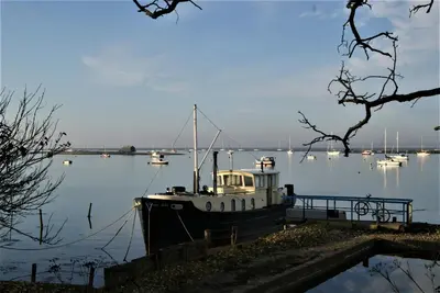 a boat is docked in the water with other boats at Secluded Island Retreat - in the heart of the Anchorage in West Mersea